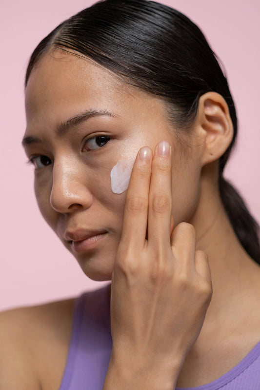 Lady applying face cream