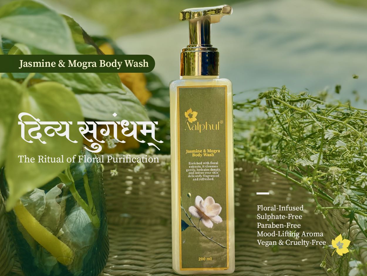 Aalphul Jasmine & Mogra Body Wash bottle with green leaves and flowers in the background