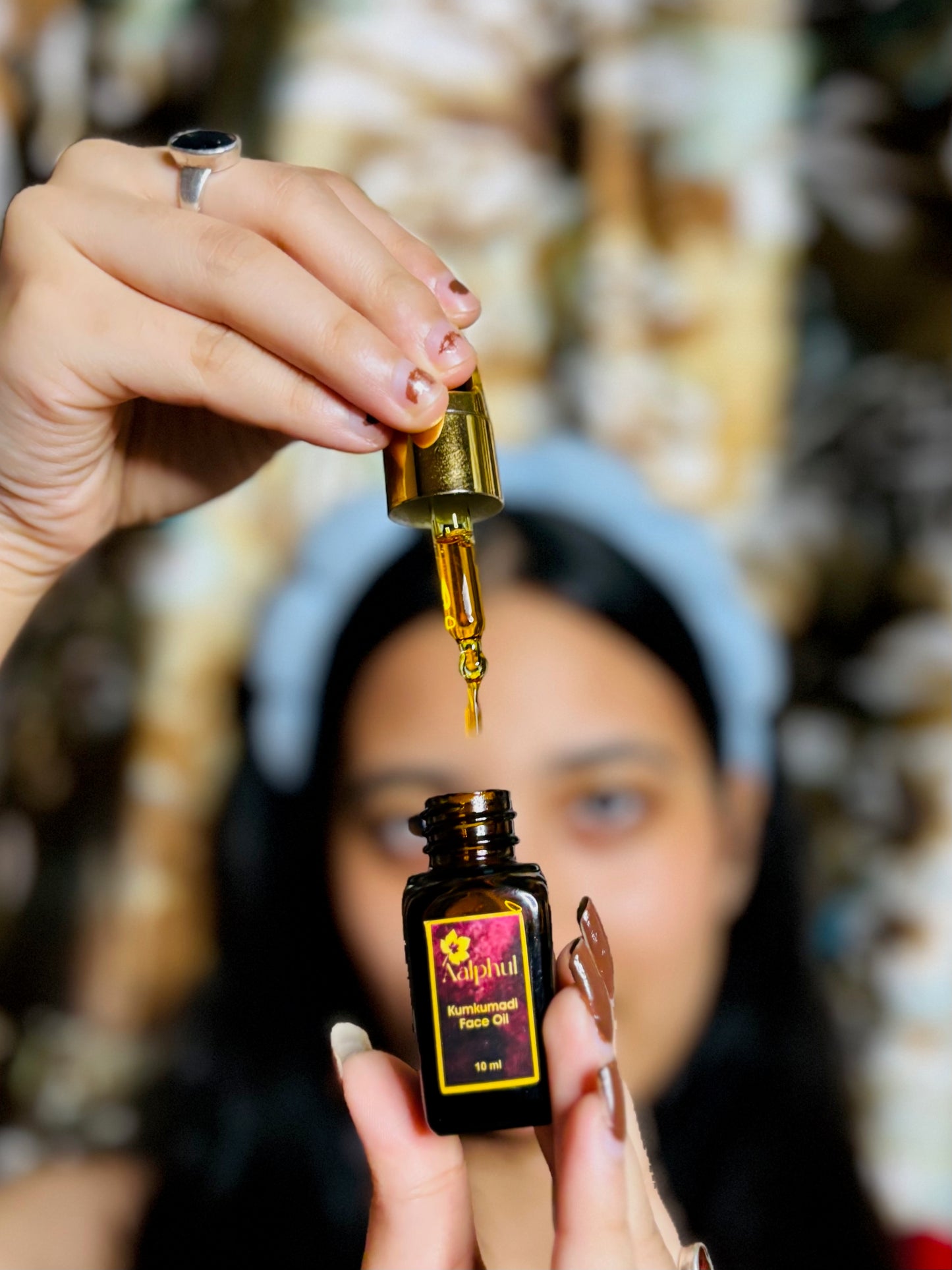Aalphul Kumkumadi Face Oil Display Image showing the bottle being held by hand