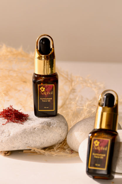 Aalphul Kumkumadi Face Oil Bottles in dsiplay image with Saffron and another herb