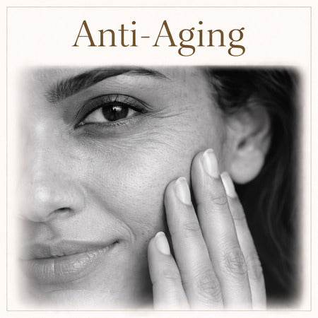 Close-up of a woman's face with visible signs of aging, touching her cheek, against a white background with 'Anti-Aging' text.