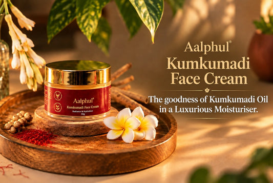 A jar of Aalphul Kumkumadi Face Cream sits on a round wooden tray, styled with a saffron strands and green botanicals in a warm, sunlit setting. 