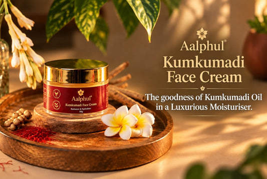 A jar of Aalphal Kumkumadi Face Cream sits on a round wooden tray, styled with a saffron strands and green botanicals in a warm, sunlit setting. 